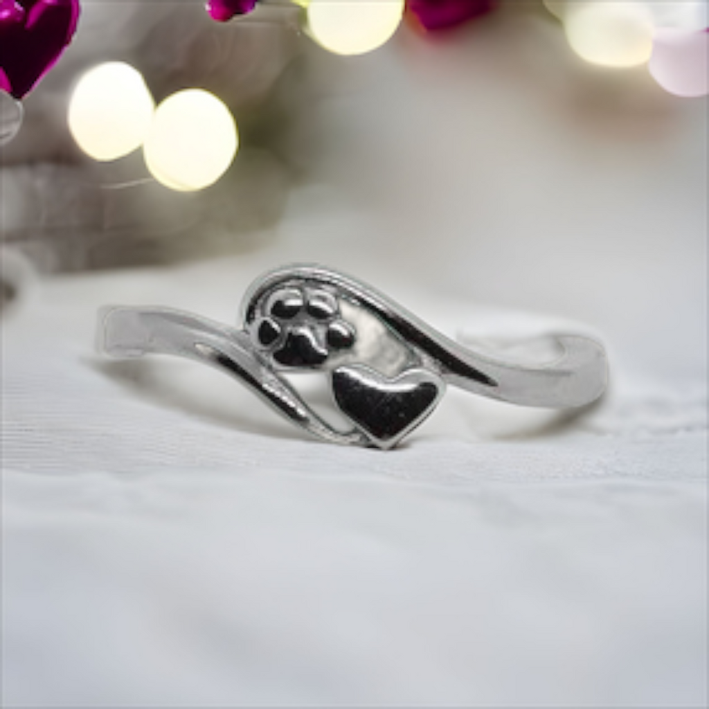 Delicate silver sterling ring with paw and heart shaped decal. 